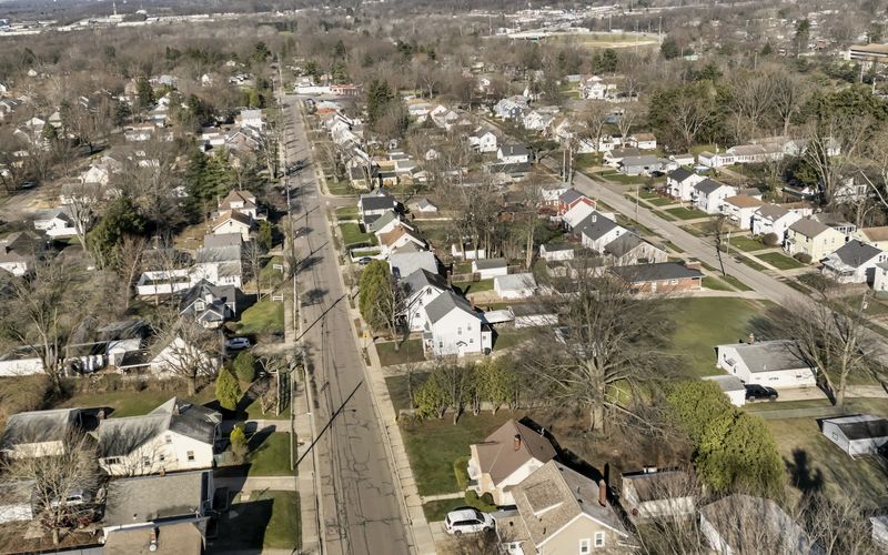 Aerial view of a suburban neighborhood with a long street