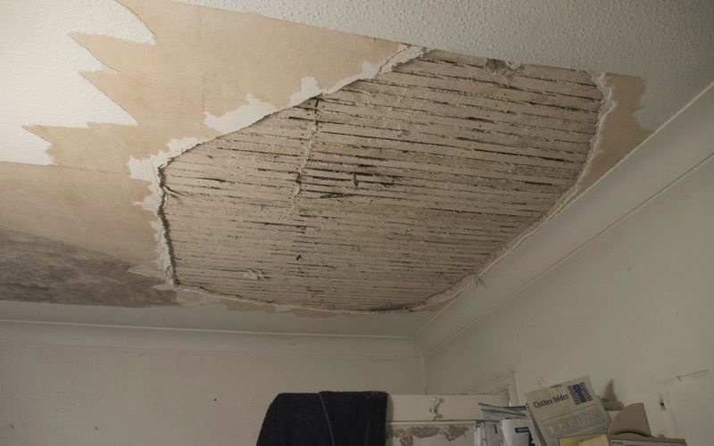 A room with a ceiling that has been torn off