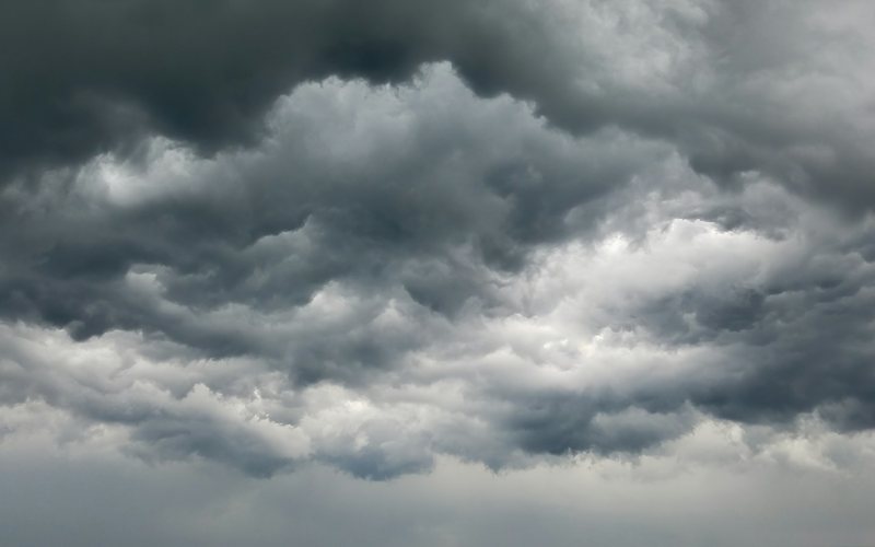 Dense dark grey storm clouds filling the sky