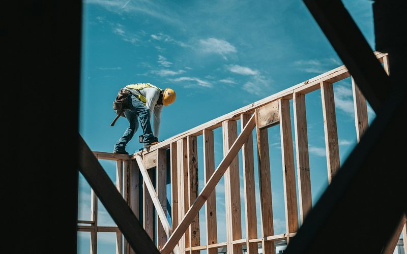 construction worker in hard hat on building frame