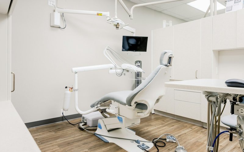 a dental room with a desk and chairs
